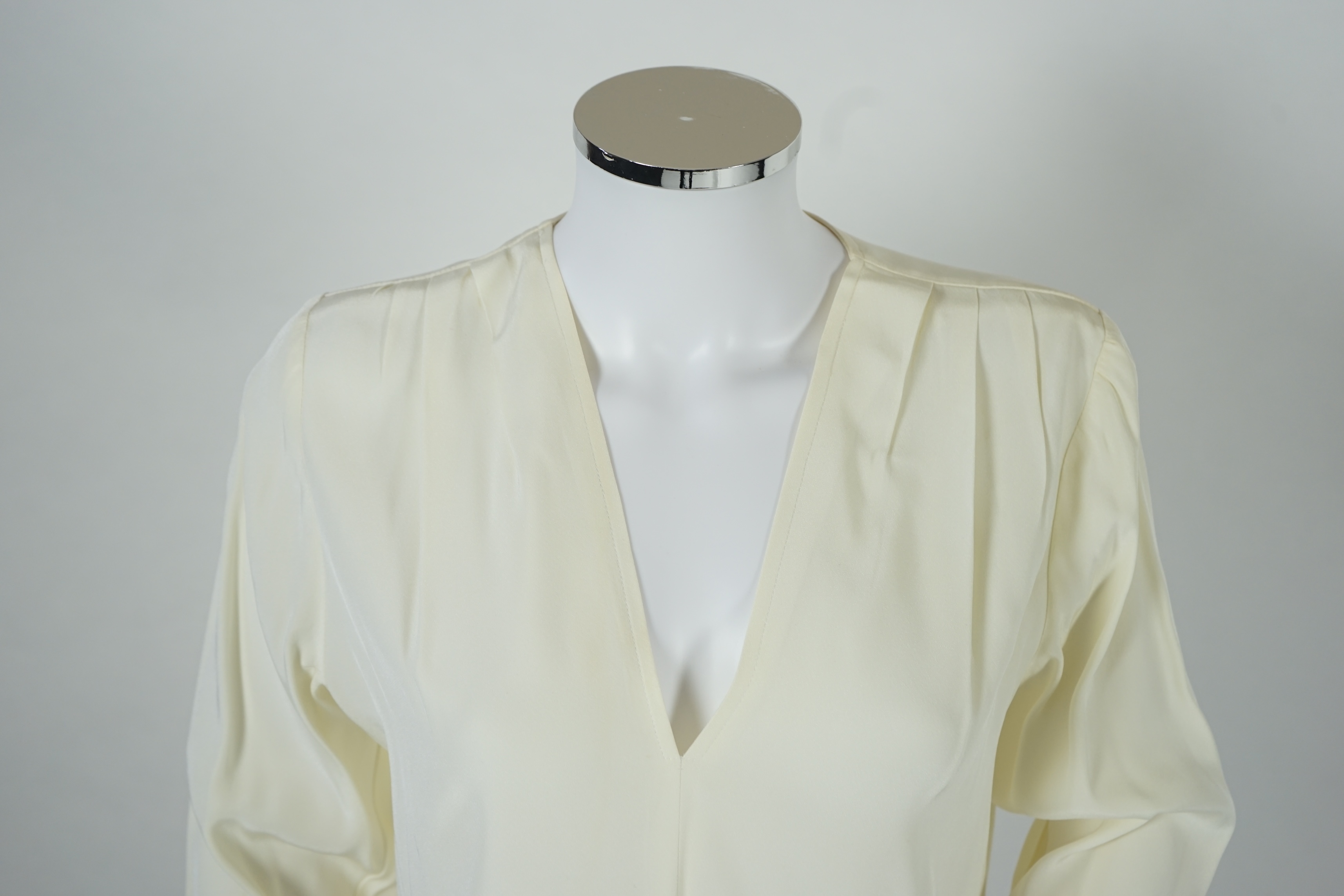 Four vintage Yves Saint Laurent variation lady's tops, F 40 (UK 12).Proceeds to Happy Paws Puppy Rescue